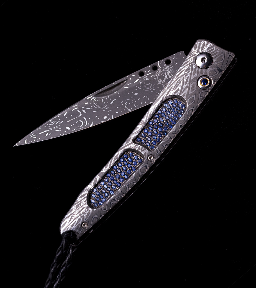 The B06 'Ventana' pocketknife in hand forged damascus, inlaid with a pave of 178 light and dark blue sapphires (2.36K) The B06 'Ventana' pocketknife in hand forged damascus, inlaid with a pave of 178 light and dark blue sapphires (2.36K)