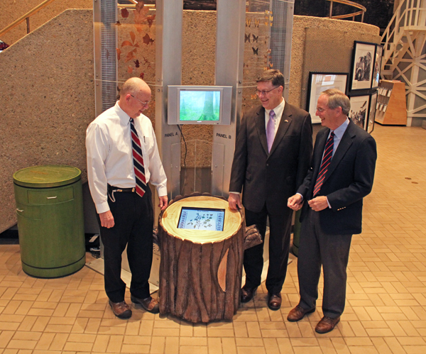The Tree Stump kiosk, purchased by the AMSE Foundation, identifies the various specimens in the Great Smoky Mountains Biodiversity Towers. AMSE Director Jim Comish (left) demonstrates the Tree Stump kiosk touch screen to AMSE Foundation members Bill Klemm, Y-12 Representative (center) and Wayne Stevenson, AMSE Foundation President (right). The Tree Stump kiosk, purchased by the AMSE Foundation, identifies the various specimens in the Great Smoky Mountains Biodiversity Towers. AMSE Director Jim Comish (left) demonstrates the Tree Stump kiosk touch screen to AMSE Foundation members Bill Klemm, Y-12 Representative (center) and Wayne Stevenson, AMSE Foundation President (right).