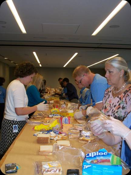 Invesco employees assembling sandwiches for homeless. Invesco employees assembling sandwiches for homeless.