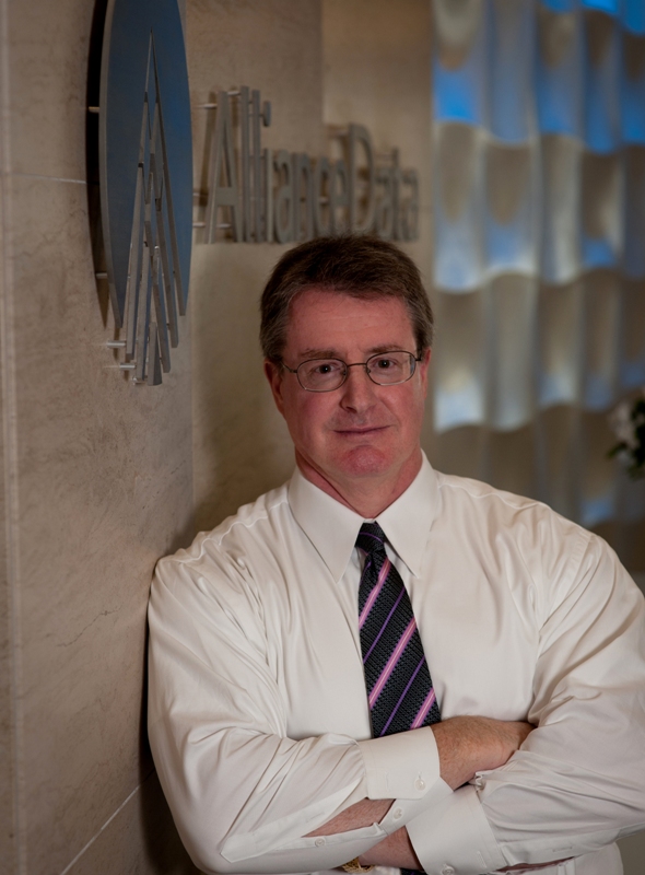 Ed Heffernan, pictured with the Alliance Data logo on the wall in the company's new headquarters building in North Texas. Ed Heffernan, pictured with the Alliance Data logo on the wall in the company's new headquarters building in North Texas.